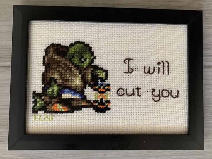 Tania's cross stitch of Tonberry. It shows Tonberry holding its lantern and says "I will cut you"