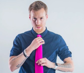 Profile picture of Theology. He's looking intensely at the camera, straightening a long tie, has verses written on his forearms, and is wearing bracelets and a watch.
